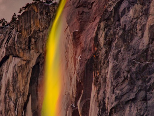 The Majestic Dance: Where Waterfalls Meet Cliff Faces